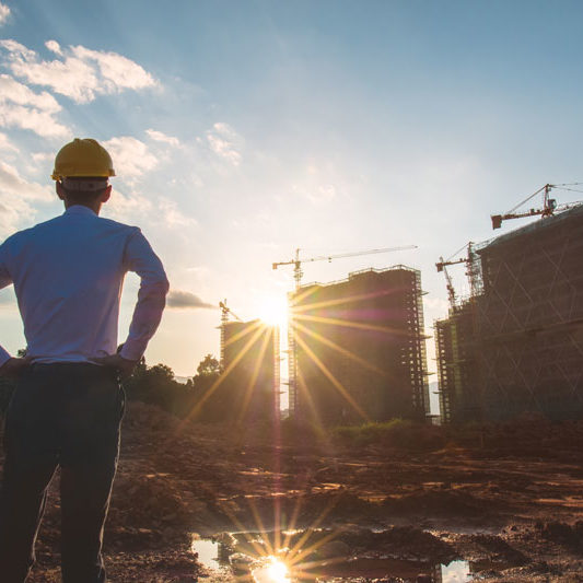 Construction-Site-Sun-Behind-Buildings
